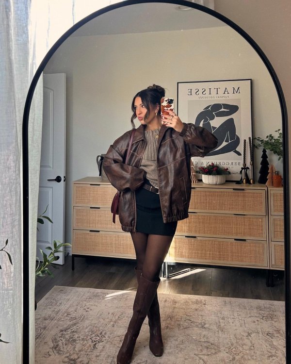 woman wearing brown leather jacket and black skkirt, fall inspired outfit