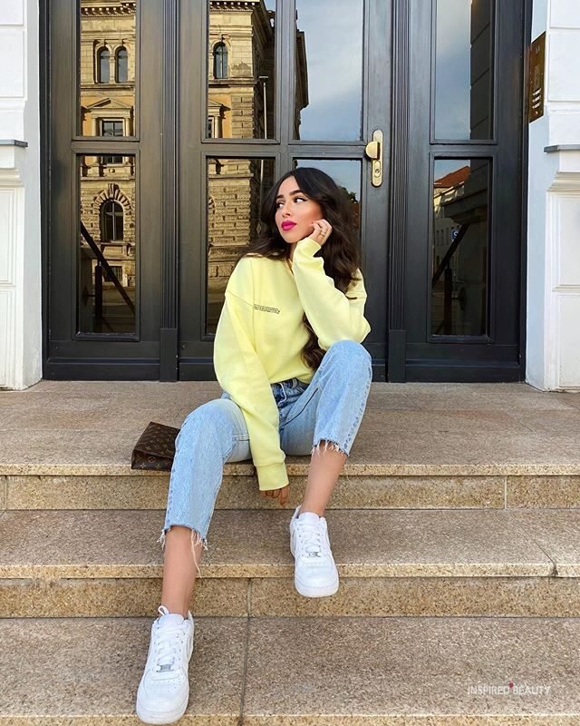 bright yellow sweatshirt sweater with blue denim and white sneakers