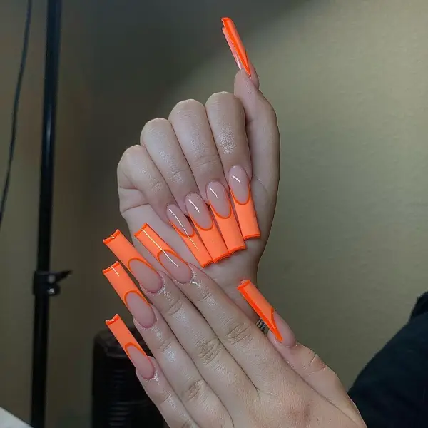 Beautiful long orange French Tip nails 