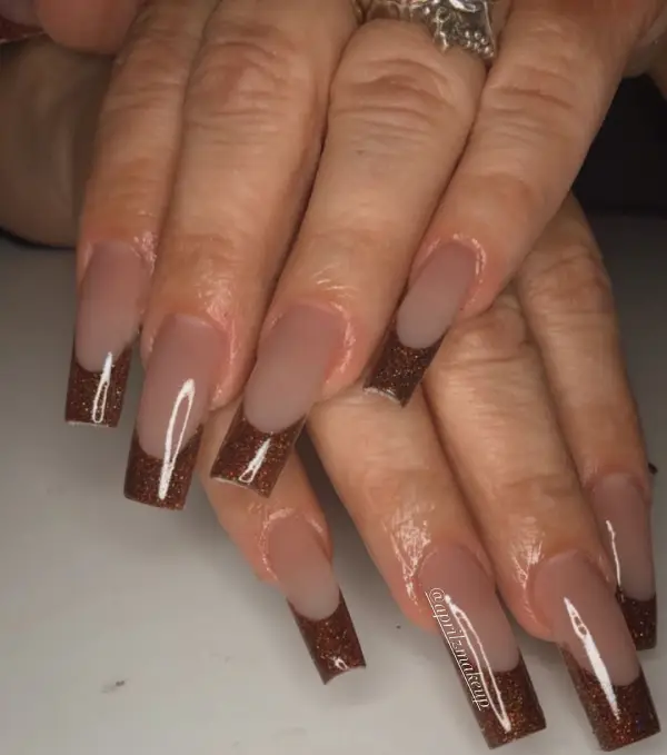 Long Brown French tip coffin nails with glitter