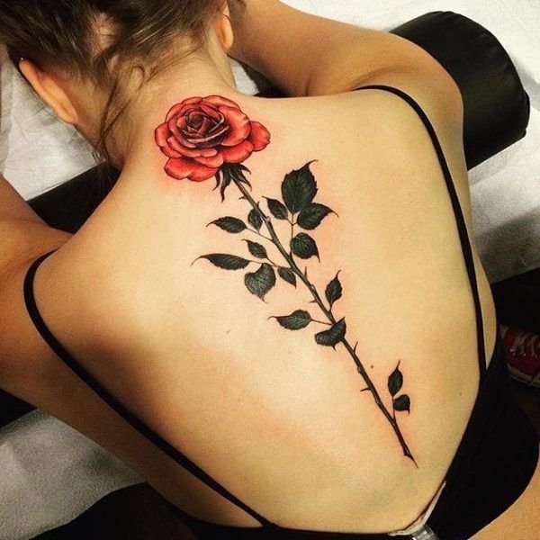 Bright big full color rose spine tattoo 