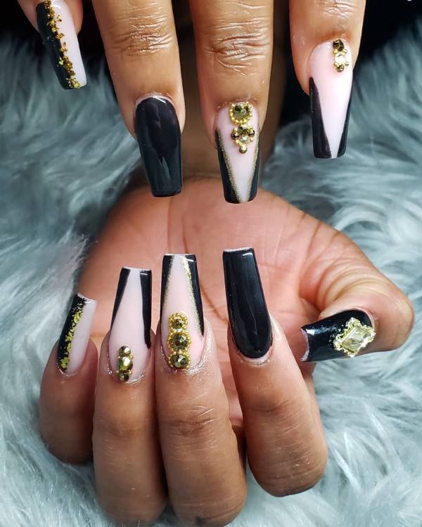 black and white nails with gold rhinestones