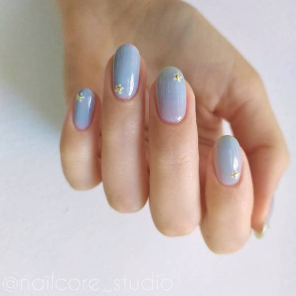 Blue nail polish with flowers design minimalist nail art