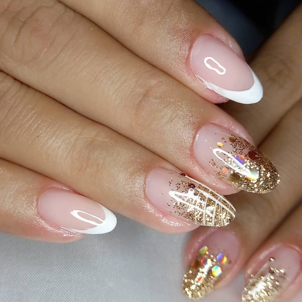 White French tip nails with gold and glitter new years eve nails 