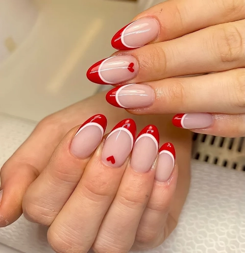 lovely almond shape nails. red and white tips and small dotted heart