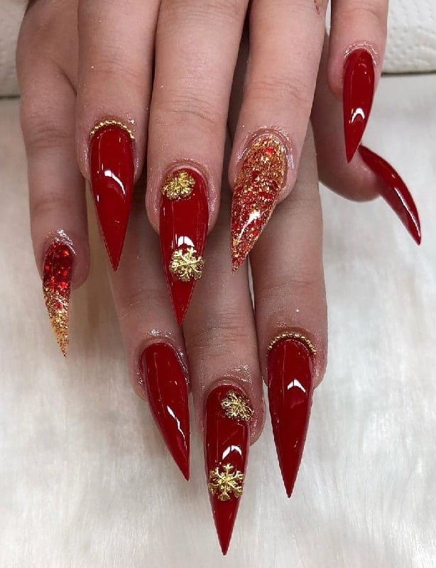 Long Christmas nails with red and gold snowflake design