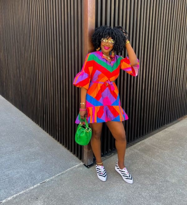 Colorful dress with black and white stripe sneakers.