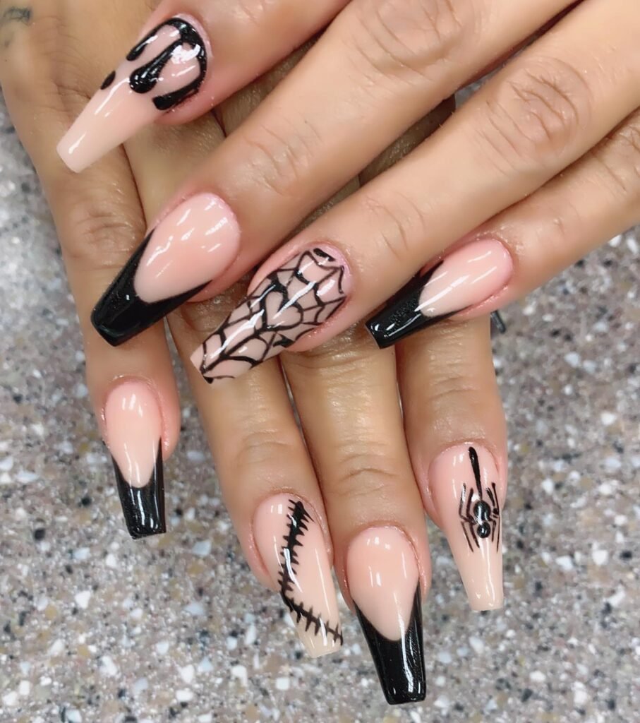 drip accent manicure with spider and patched design