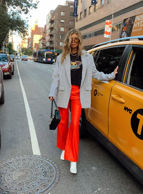 red flare pants, blazer and white ankle boots