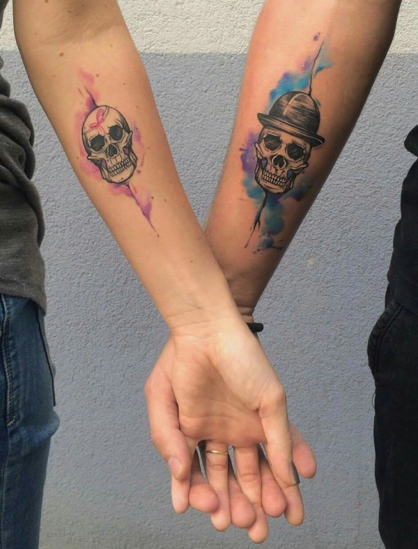 Matching skull tattoos