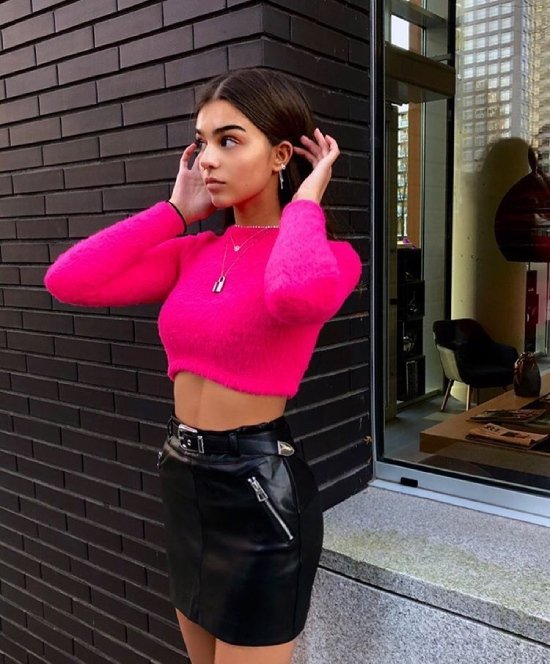 hot pink cropped top and black leather skirt
