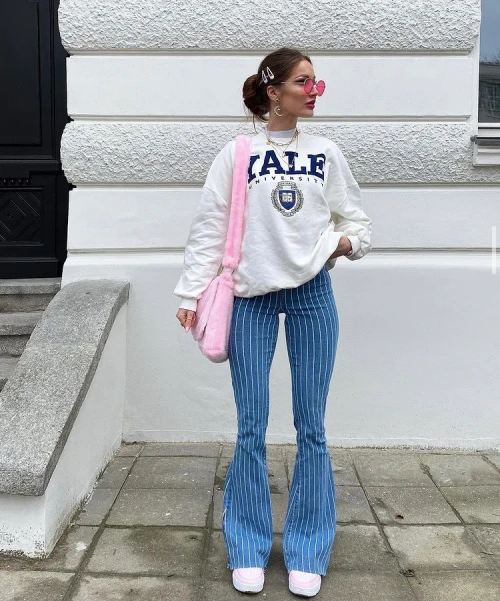 White long-sleeve sweatshirt with Stripped blue and white flare pants outfit idea