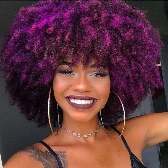Black woman with purple curly dye hair