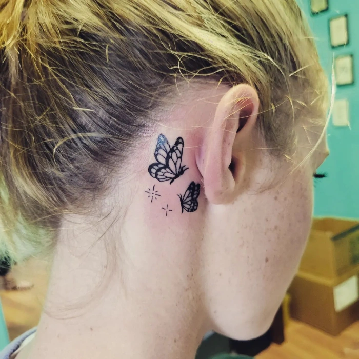 butterflies tattoo behind ear