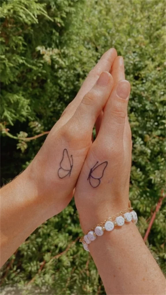 Matching butterfly hand tattoo