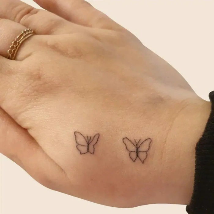 hand butterflies tattoo