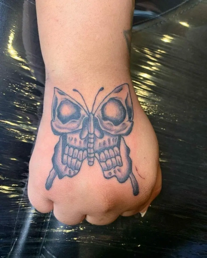 Skull hand tattoos butterfly