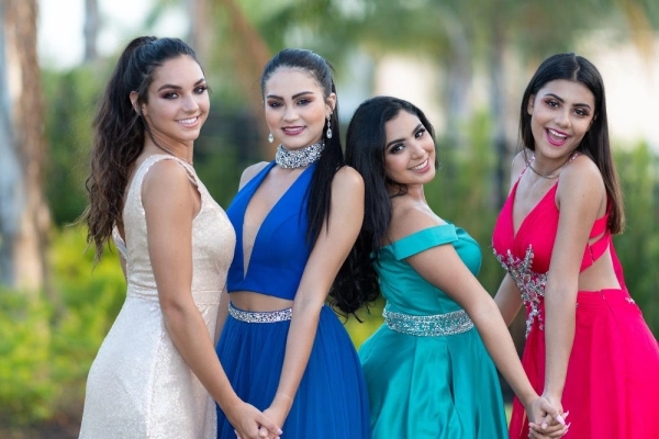 happy teenage girls in dresses outside