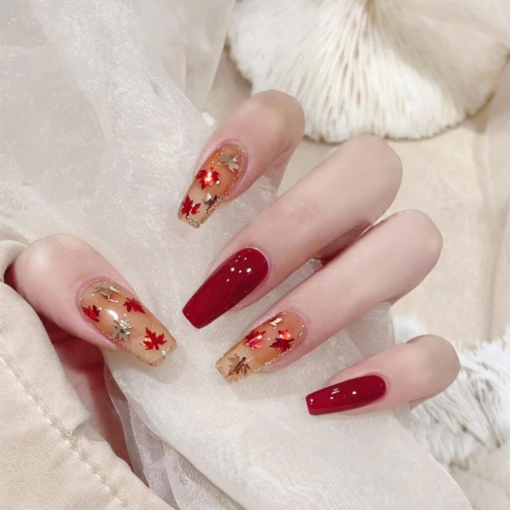 The Perfect Red Glitter Fall Leaf Nails Design is long and cute