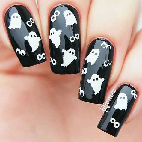 Shiny Black Nails with white ghost boo cute Halloween nails. 