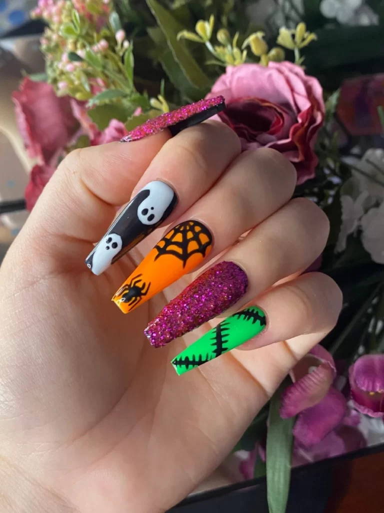 Black and white ghost nails with orange, black green Halloween design
