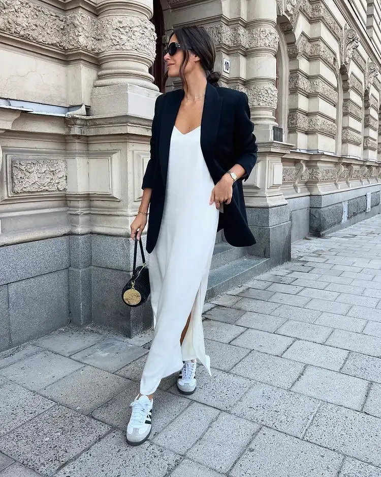 black blazer with white slip dtess and adidas sneakers