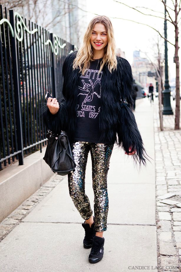 Black sequin pants with a black top and boots