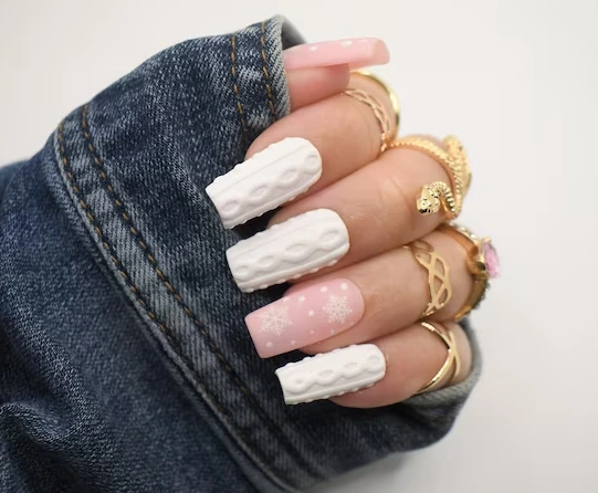 pink accent nails with snowflake, white sweater design 