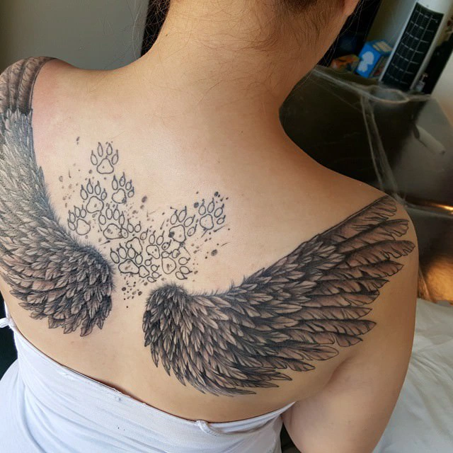 Large tattoo Idea with angel wings and dog paws