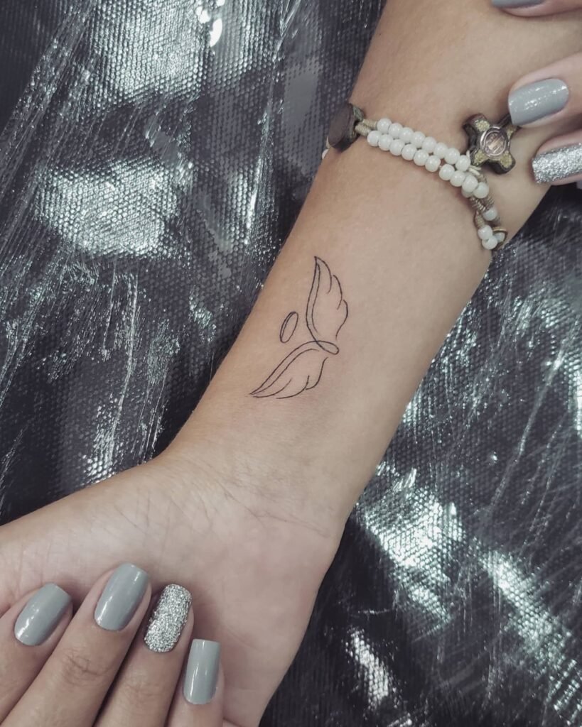 Minimalistic Angel Wing Wrist Tattoo
