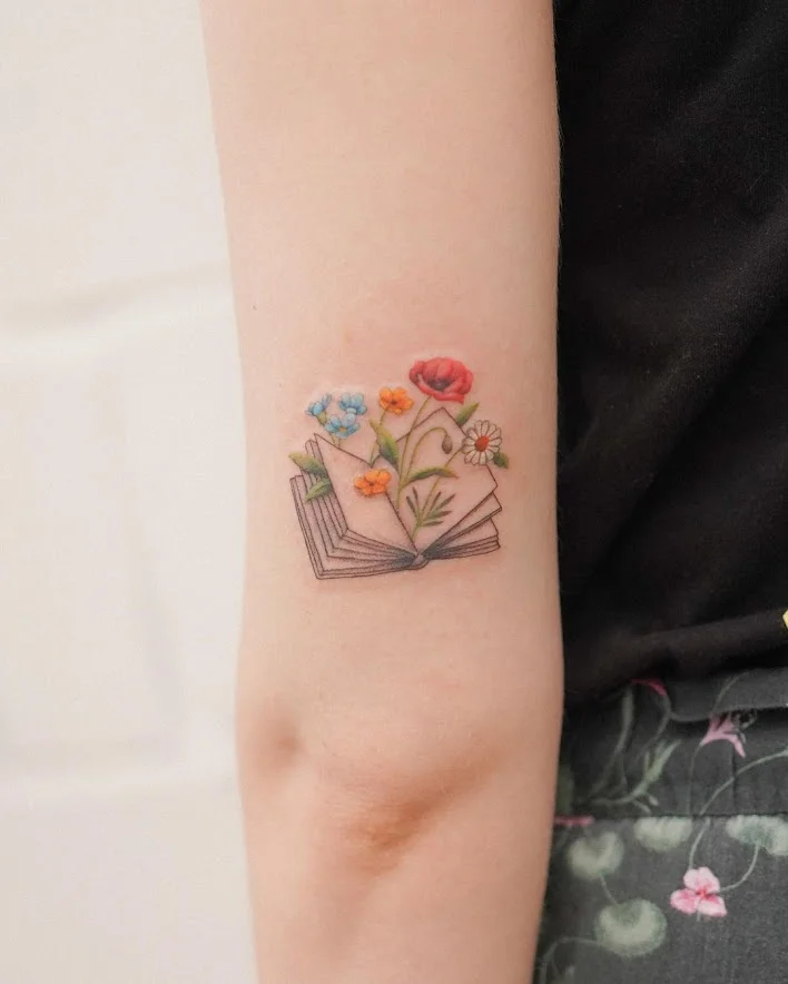 colorful flowers in the book tattoo