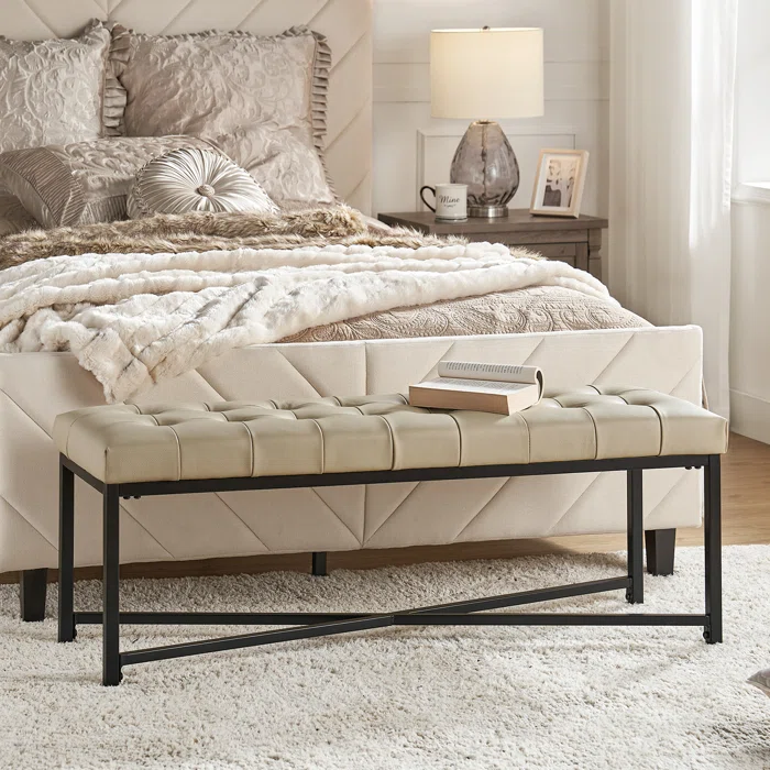 Image of beige bedroom with sheets and beige bed bench