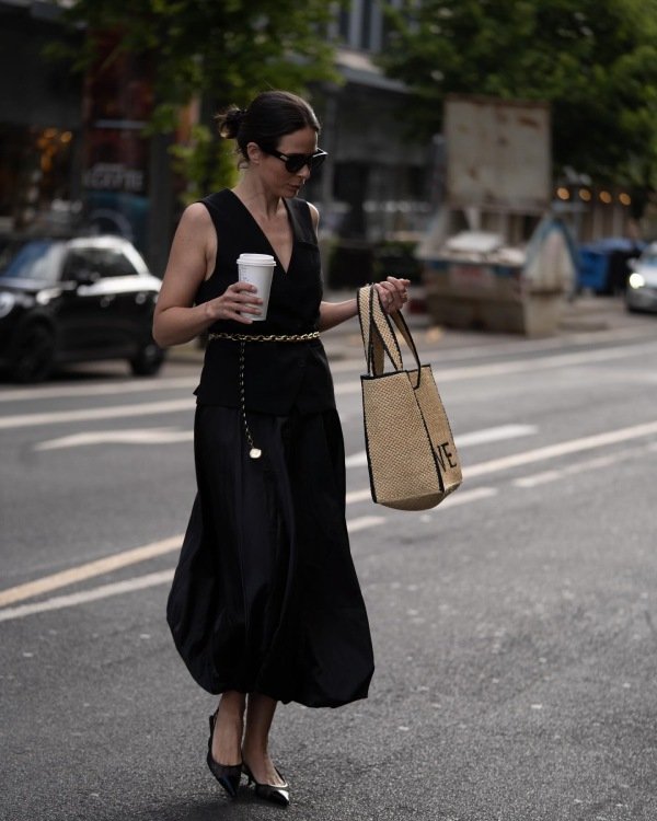 fall skirt look with long black bubble skirt. Woman wearing bubble skirt crossing street.