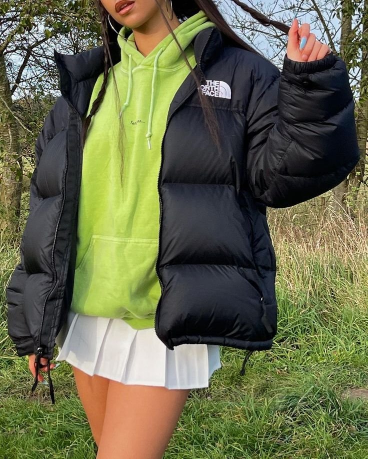 Black Puffer Jacket with Green Hooded Sweatshirt and White Pleated Mini Skirt