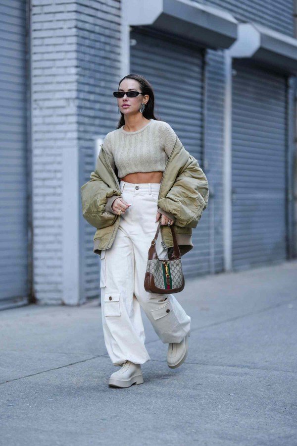 Trendy fall outfit with a cropped beige sweater, cargo pants, and chunky platform boots.