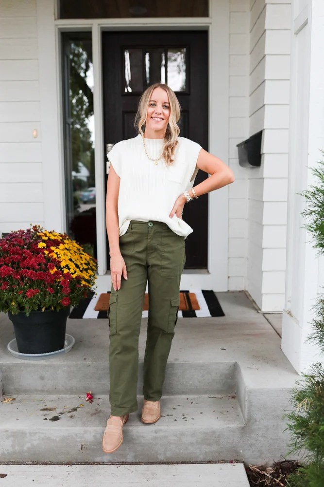 women wearing Sweater Tank & Loafers with green cargo pants outside the house