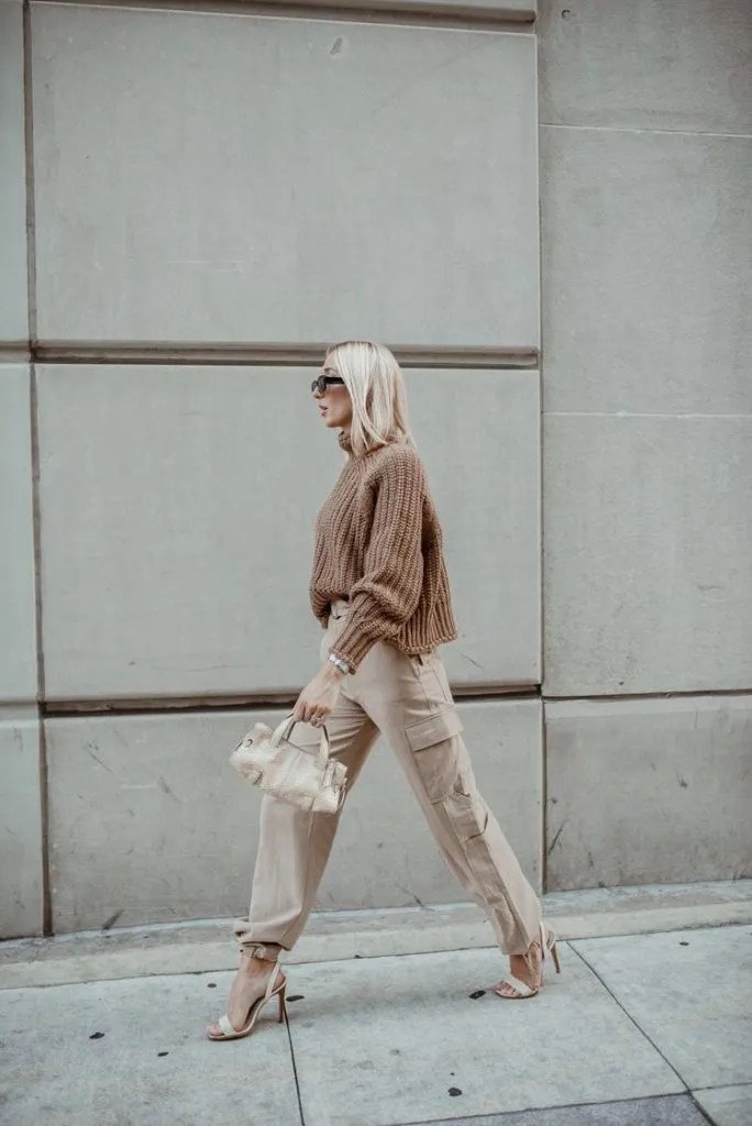 how to wear cargo pants, Elegant casual look with a fitted beige knit top, olive green cargo pants, and ankle strap heels