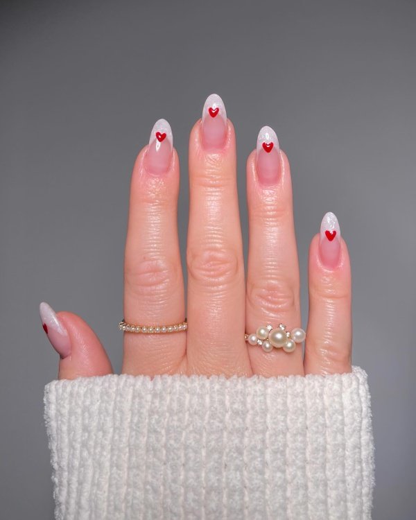 red and white french manicure with hearts on top