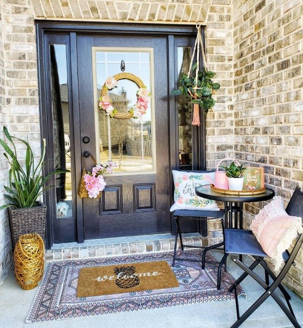 Hanging baskets filled with pink and purple flowers on a porch.