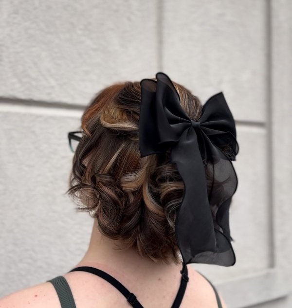 Short prom hiarstyle with a satin bow that looks good with baby doll dress. Short hair cwith lovely curls.