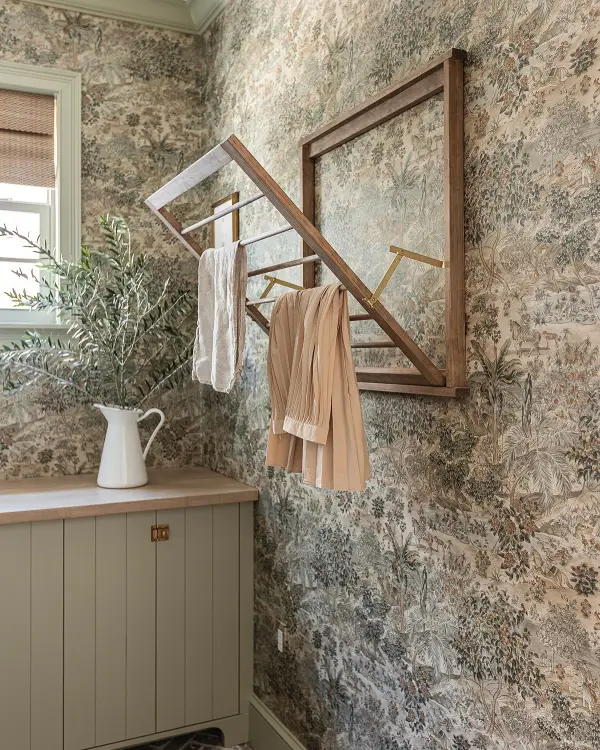 A wall-mounted drying rack folds out for air-drying clothes. When not in use, it tucks flat against the wall to save space.