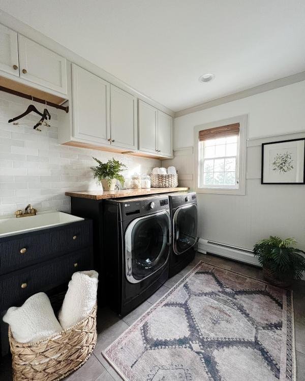 Sleek cabinets above and beside the machines hide clutter and supplies. They add a built-in look and offer plenty of hidden storage.