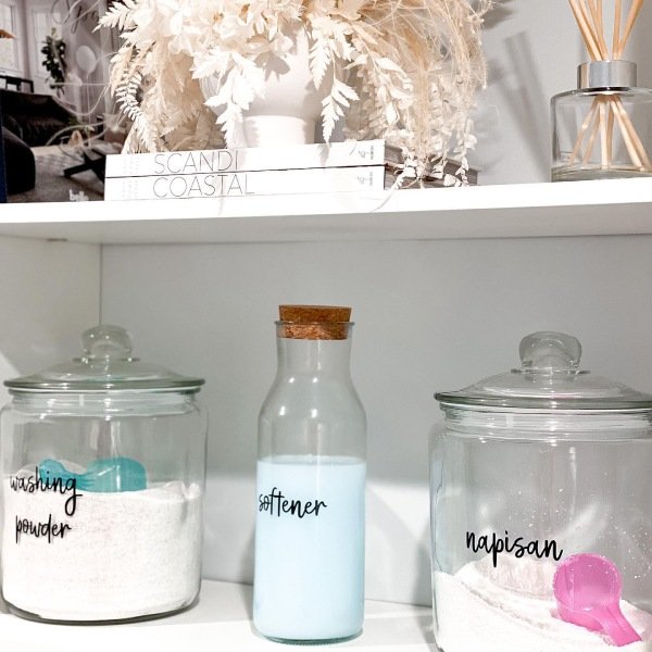 Labeled StorageClear bins and jars are neatly labeled with words like “Detergent” and “Stain Remover.” Labels help keep everything organized and easy to find.