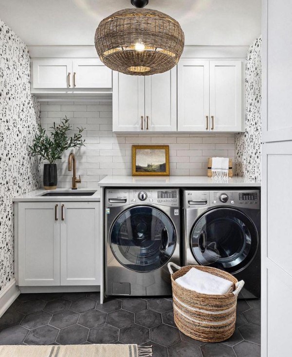 Woven baskets in natural tones store towels and laundry items on open shelving. They add warmth and texture to the laundry room decor.