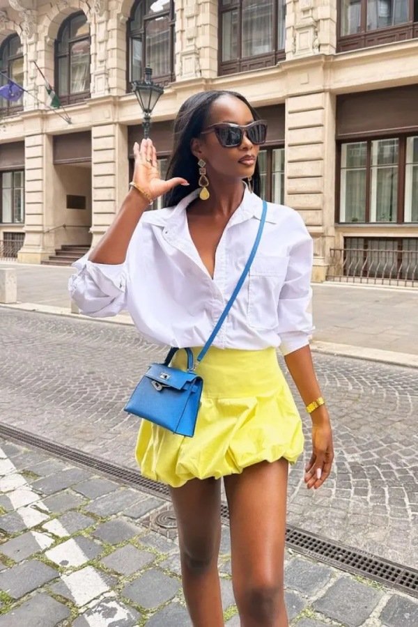 yellow Puffball Skirt Outfit, black woman wearing a bubble skirt and white shirt.