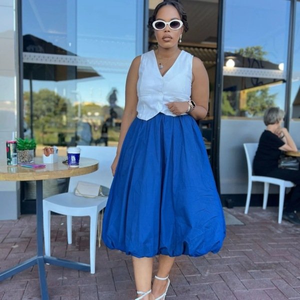 bubble skirt outfit ideas for any season. Woman wearing long blue bubble skirt and sleeveless blouse