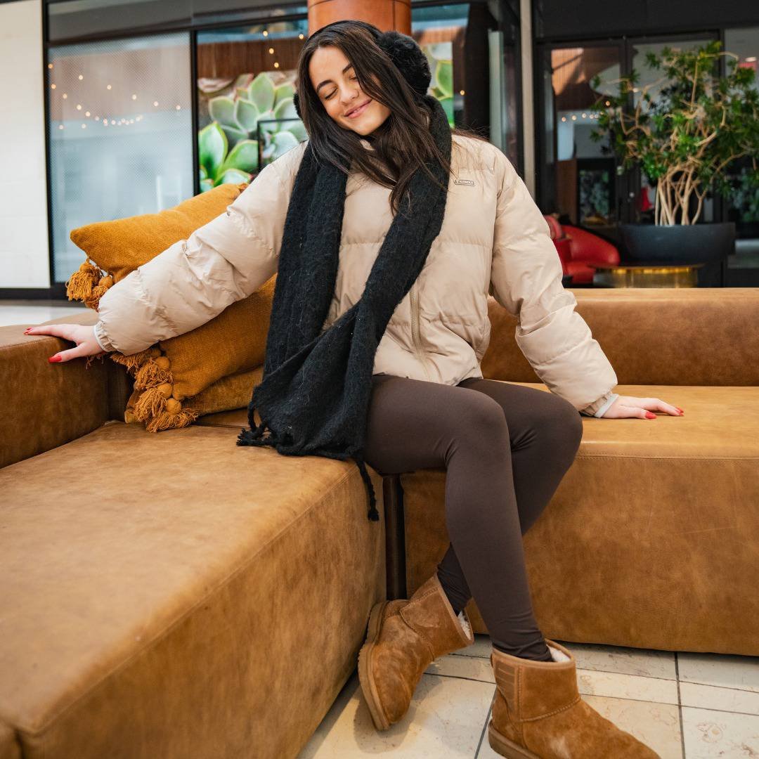 Brown Leggings with a Puffer Jacket, scarf, and Ugg Boots