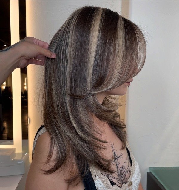 Chunky blonde highlight on brunette hair