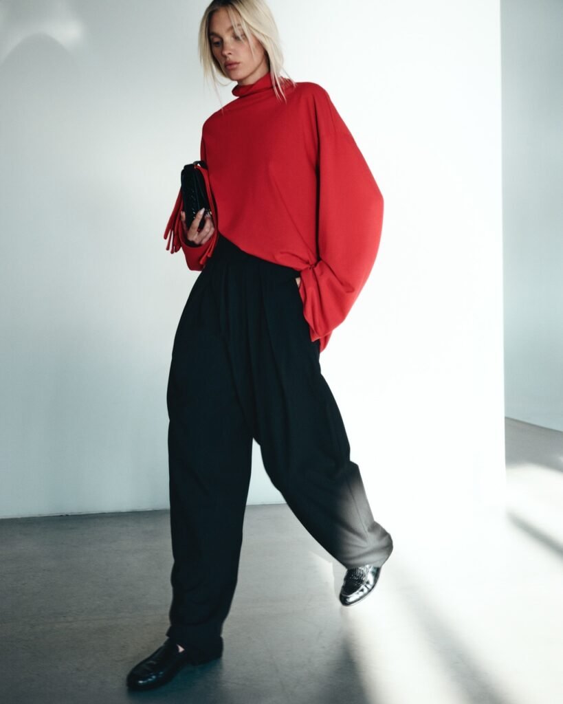 Tailored High Waist Pleated Suit Trouser for Holiday party look. Woman wearing chic and modern style.