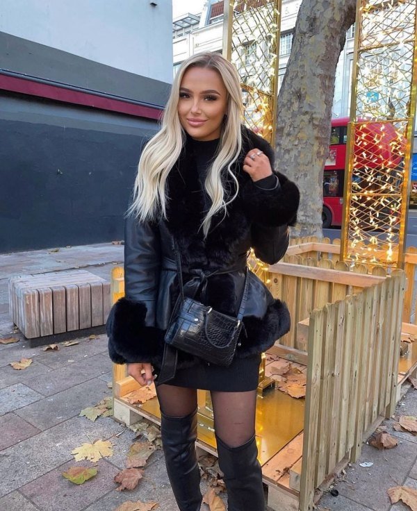 This is a black faux leather belted jacket with faux fur trim, possibly from the brand Azalea Wang. Classy winter outfit that are easy to copy.